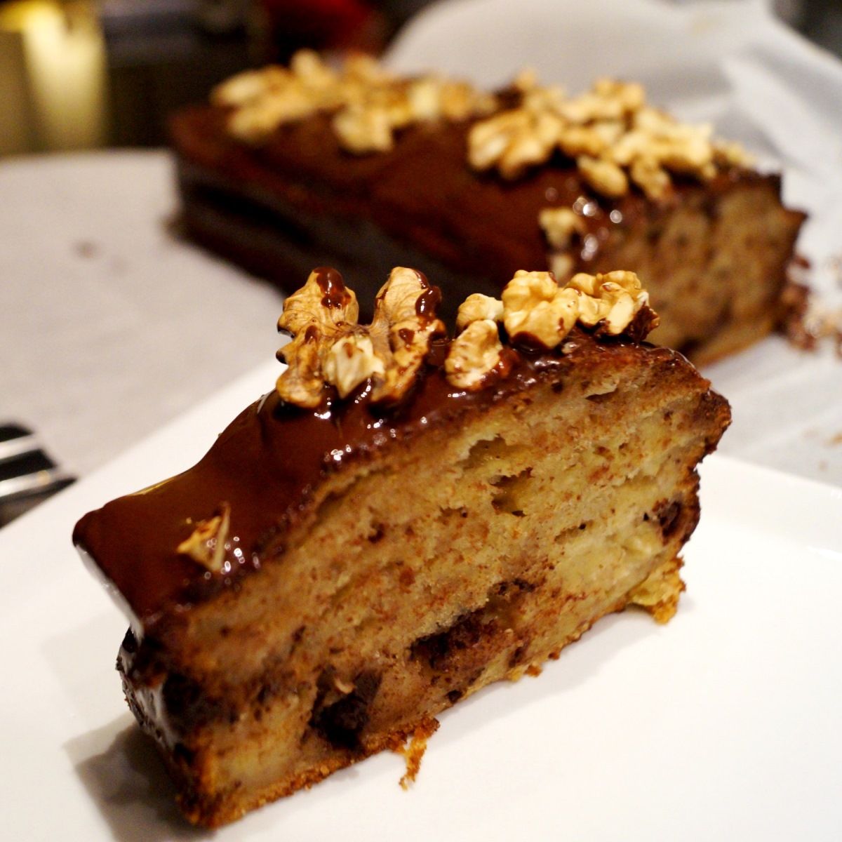 Banankage med chokolade og pyntet med valnødder