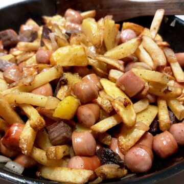 Kartofler, oksekød, pølser og løg vendes sammen på panden